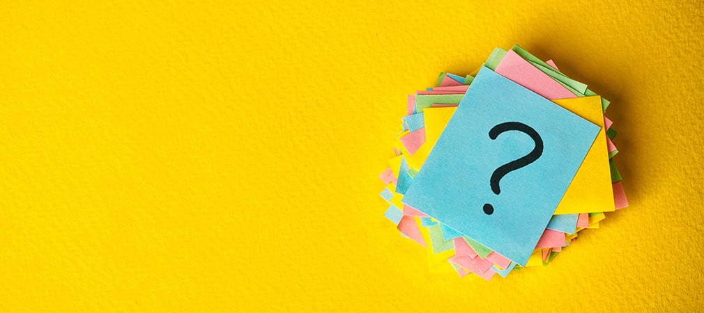 Question mark on a pile of sticky notes